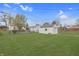 Lush backyard with a detached garage, providing ample space for recreation and storage at 620 S Irvington Ave, Indianapolis, IN 46219