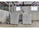 Unfinished basement laundry area with a set of a washer and dryer next to the wall at 620 S Irvington Ave, Indianapolis, IN 46219