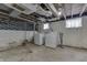 Basement with exposed ceiling featuring a washer and dryer set and unfinished walls and floors at 620 S Irvington Ave, Indianapolis, IN 46219