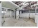 Unfinished basement featuring open ceiling framework, concrete flooring and cement walls at 620 S Irvington Ave, Indianapolis, IN 46219
