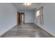 Bright bedroom with wood-look floors and access to additional rooms at 620 S Irvington Ave, Indianapolis, IN 46219