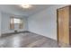 Bedroom with wood-look floors and light-blue walls, featuring a closet and a window at 620 S Irvington Ave, Indianapolis, IN 46219