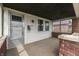 Inviting covered porch with brick accents, offering a cozy outdoor space at 620 S Irvington Ave, Indianapolis, IN 46219