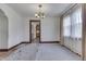 Bright dining room featuring chandelier, large window and archway at 620 S Irvington Ave, Indianapolis, IN 46219