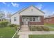 Charming home featuring a gabled roof, brick accents, and a covered front porch at 620 S Irvington Ave, Indianapolis, IN 46219