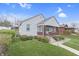 Quaint home with a covered porch and nicely landscaped front yard at 620 S Irvington Ave, Indianapolis, IN 46219