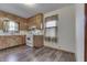 Functional kitchen with wood cabinets, white appliances, and a window over the sink at 620 S Irvington Ave, Indianapolis, IN 46219