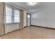 Well-lit living room with hardwood floors, window and traditional-style curtains at 620 S Irvington Ave, Indianapolis, IN 46219