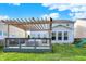 Lush backyard featuring a deck with pergola, lawn, and a swing set at 6650 W Black Tail Way, McCordsville, IN 46055