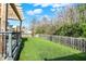 Lush backyard featuring a deck with pergola, lawn, and wooden privacy fence at 6650 W Black Tail Way, McCordsville, IN 46055
