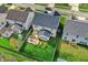 Aerial view of a backyard featuring a deck with pergola, playset, green lawn, and privacy fence at 6650 W Black Tail Way, McCordsville, IN 46055