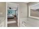 Bright bathroom featuring a tub, and access to the primary bedroom at 6650 W Black Tail Way, McCordsville, IN 46055