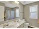 Bright bathroom features a double vanity, large mirror, and a window for natural light at 6650 W Black Tail Way, McCordsville, IN 46055
