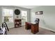 Study or bedroom features mint walls, large windows, carpet, and a wooden desk at 6650 W Black Tail Way, McCordsville, IN 46055