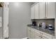 Granite countertops and white cabinets add elegance to this convenient kitchen coffee bar at 6650 W Black Tail Way, McCordsville, IN 46055