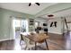 Open dining space with sliding doors and hardwood floors seamlessly connects to the living areas at 6650 W Black Tail Way, McCordsville, IN 46055
