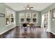 Bright dining area featuring hardwood floors, modern table, and sun-filled windows at 6650 W Black Tail Way, McCordsville, IN 46055