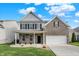 Charming two-story brick home with a well-manicured lawn and attached two-car garage at 6650 W Black Tail Way, McCordsville, IN 46055
