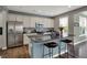 Well-appointed kitchen with stainless steel appliances, granite counters, and an island with seating at 6650 W Black Tail Way, McCordsville, IN 46055
