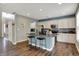 Modern kitchen with granite countertops, stainless steel appliances, and a convenient breakfast bar at 6650 W Black Tail Way, McCordsville, IN 46055