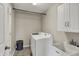 Well-equipped laundry room with washer, dryer, utility sink and storage, offering convenience at 6650 W Black Tail Way, McCordsville, IN 46055