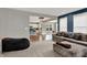 Open-concept living area with plush seating and seamless flow to dining and kitchen spaces at 6650 W Black Tail Way, McCordsville, IN 46055