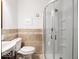 Modern bathroom with a glass shower enclosure, stylish tile work, and sleek fixtures at 7037 Indian Lake W Blvd, Indianapolis, IN 46236