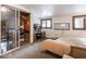 Comfortable carpeted bedroom featuring a sliding glass door, desk and sleeping quarters with two twin beds at 7037 Indian Lake W Blvd, Indianapolis, IN 46236