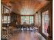 Inviting dining room features natural light, beautiful wood paneled walls and ceiling, and tiled floor at 7037 Indian Lake W Blvd, Indianapolis, IN 46236