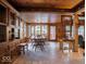 Inviting dining room features natural light, beautiful wood paneled walls and ceiling, and tiled floor at 7037 Indian Lake W Blvd, Indianapolis, IN 46236