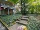 Beautifully landscaped front yard with stone steps, lighting, and lush greenery at 7037 Indian Lake W Blvd, Indianapolis, IN 46236