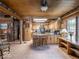 Spacious kitchen features updated appliances, counter seating, wooden cabinets, and spiral staircase at 7037 Indian Lake W Blvd, Indianapolis, IN 46236