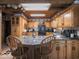 Spacious kitchen features updated appliances, granite counters, wooden cabinets, and tiled floor at 7037 Indian Lake W Blvd, Indianapolis, IN 46236