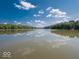 Beautiful lake view with reflection of clouds, surrounded by lush trees at 7037 Indian Lake W Blvd, Indianapolis, IN 46236