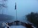 Snowy lake view with American flag and snow covered deck at 7037 Indian Lake W Blvd, Indianapolis, IN 46236