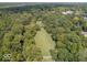 Aerial view of green space bordered by mature trees and a white fence at 7037 Indian Lake W Blvd, Indianapolis, IN 46236