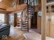 Charming living room features beautiful wooden paneling, spiral staircase, and tiled floor at 7037 Indian Lake W Blvd, Indianapolis, IN 46236