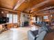 Spacious living room with fireplace, wood paneled walls, hardwood floors, and natural light at 7037 Indian Lake W Blvd, Indianapolis, IN 46236