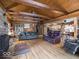 Expansive living room boasting wood floors, a stone fireplace, and a spiral staircase at 7037 Indian Lake W Blvd, Indianapolis, IN 46236