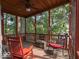 Cozy screened-in porch featuring comfortable seating and scenic views of the surrounding greenery at 7037 Indian Lake W Blvd, Indianapolis, IN 46236