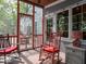 Charming screened-in porch with rocking chairs, perfect for relaxing and enjoying the outdoors at 7037 Indian Lake W Blvd, Indianapolis, IN 46236