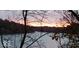Scenic lake view at sunset with colorful sky and peaceful water at 7037 Indian Lake W Blvd, Indianapolis, IN 46236
