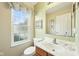 Well-lit half bathroom featuring a window, vanity with a sink, and tasteful decorations, creating a serene and functional space at 715 Stockbridge Dr, Westfield, IN 46074