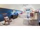 Bedroom with blue accent wall, sitting area, and a rocking chair at 715 Stockbridge Dr, Westfield, IN 46074