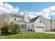 Exterior showcasing a well-maintained house with a sunroom, deck, manicured lawn, and an attached two car garage at 715 Stockbridge Dr, Westfield, IN 46074