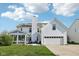 Beautiful home exterior featuring a screened in porch, attached garage, and well-maintained lawn at 715 Stockbridge Dr, Westfield, IN 46074