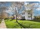 Beautifully landscaped home with a well-manicured lawn, lush trees, and an American flag displayed at 715 Stockbridge Dr, Westfield, IN 46074