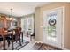 Inviting foyer with a decorative front door, adjacent to a dining room with ample natural light at 715 Stockbridge Dr, Westfield, IN 46074