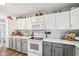 White kitchen with marble countertops and stainless steel appliances at 715 Stockbridge Dr, Westfield, IN 46074