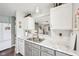 Bright kitchen with white cabinets, marble countertops, and stainless steel sink at 715 Stockbridge Dr, Westfield, IN 46074